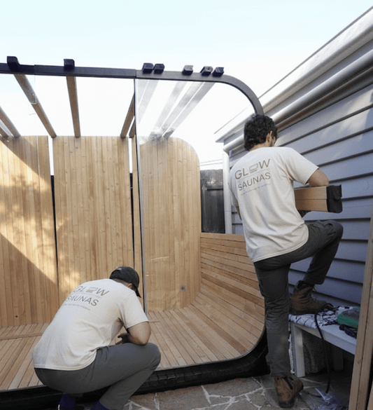  Glow Sauna crew installing a modern outdoor sauna.